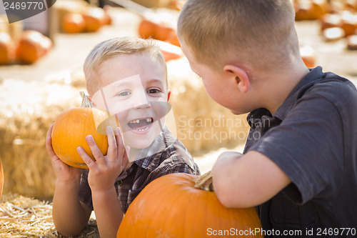 Image of Two Boys at the Pumpkin Patch Talking and Having Fun
