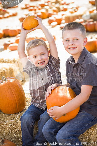 Image of Two Boys at the Pumpkin Patch Talking and Having Fun
