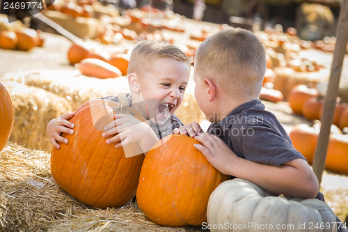 Image of Two Boys at the Pumpkin Patch Talking and Having Fun
