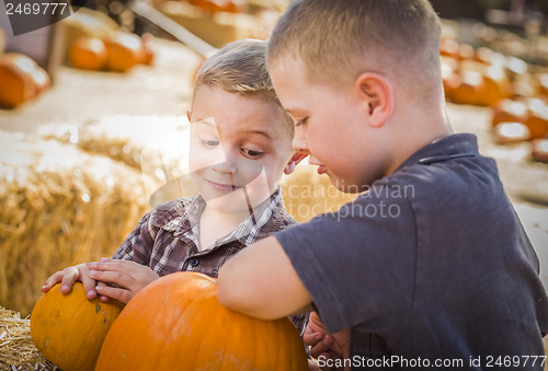 Image of Two Boys at the Pumpkin Patch Talking and Having Fun
