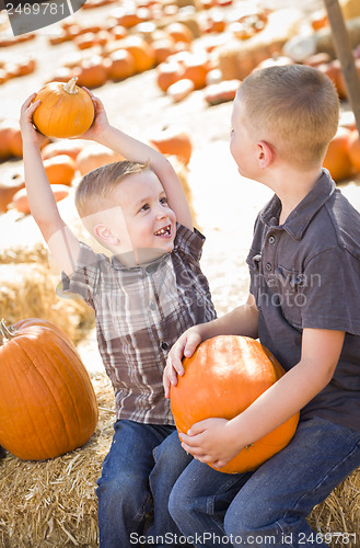 Image of Two Boys at the Pumpkin Patch Talking and Having Fun
