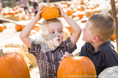 Image of Two Boys at the Pumpkin Patch Talking and Having Fun
