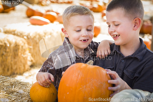 Image of Two Boys at the Pumpkin Patch Talking and Having Fun
