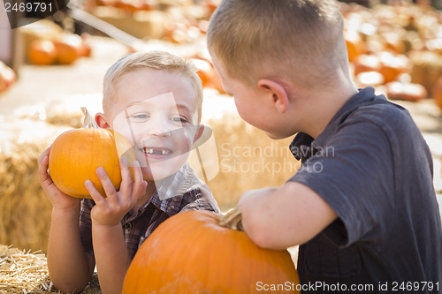 Image of Two Boys at the Pumpkin Patch Talking and Having Fun
