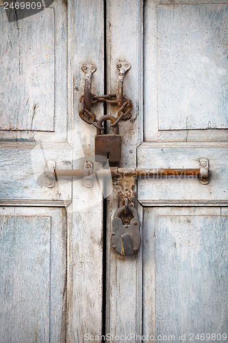 Image of Two padlocks on the old door
