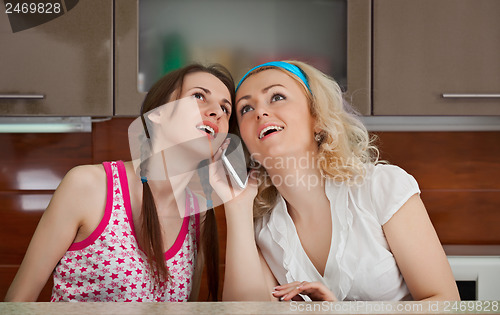 Image of Two young girls make a phone call