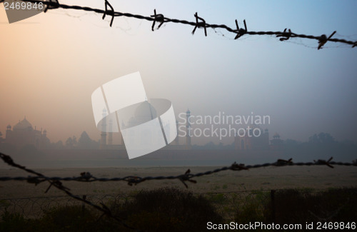 Image of Taj Mahal from the riverside, trough barbed wire