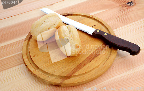 Image of Closeup of two fresh petit pain with a bread knife