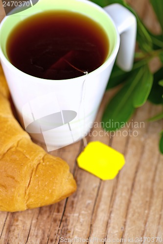 Image of cup of tea and fresh croissant 