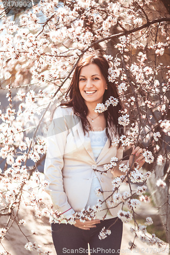 Image of Pregnant woman in the flowering branches
