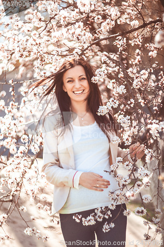 Image of Pregnant woman in the flowering branches