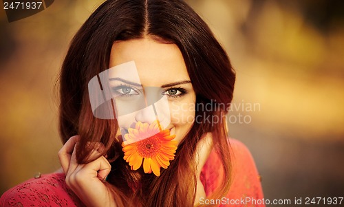 Image of Girl with a flower in his mouth