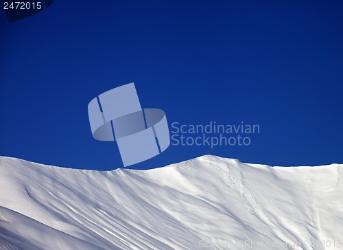 Image of Off-piste slope and blue clear sky in nice winter day