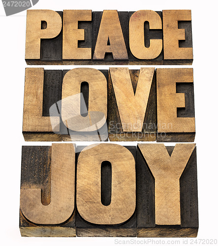 Image of peace, love and joy in wood type