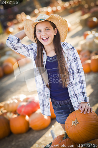 Image of Preteen Girl Playing with a Wheelbarrow at the Pumpkin Patch
