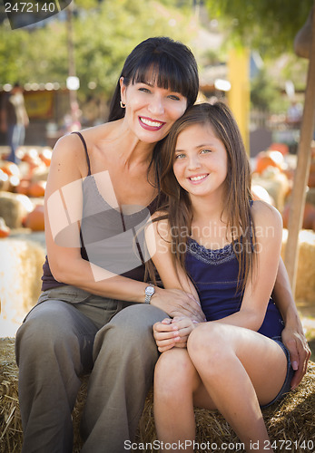 Image of Attractive Mother and Daughter Portrait at the Pumpkin Patch
