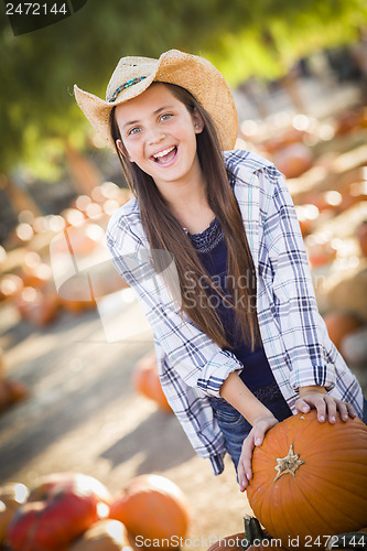 Image of Preteen Girl Playing with a Wheelbarrow at the Pumpkin Patch
