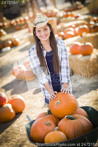 Image of Preteen Girl Playing with a Wheelbarrow at the Pumpkin Patch
