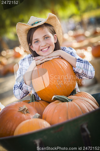 Image of Preteen Girl Playing with a Wheelbarrow at the Pumpkin Patch
