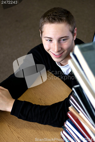 Image of Student Looking At Book Stack