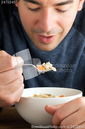 Image of Man Eating Chicken Soup