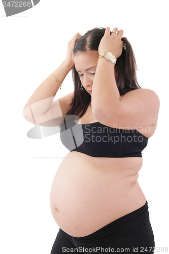 Image of A young pregnant woman is experiencing the discomfort of pregnan