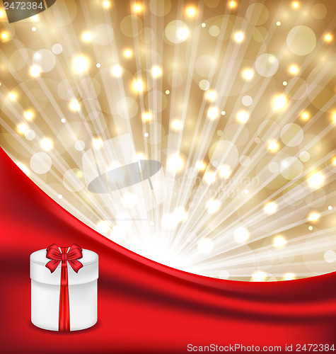 Image of Gift box with red bow on glowing background