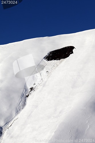Image of Trace of avalanche on off piste slope in sun day. Close-up view.