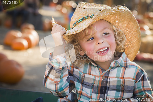 Image of Little Boy in Cowboy Hat at Pumpkin Patch