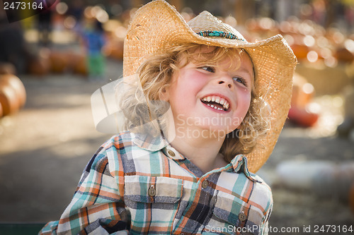 Image of Little Boy in Cowboy Hat at Pumpkin Patch