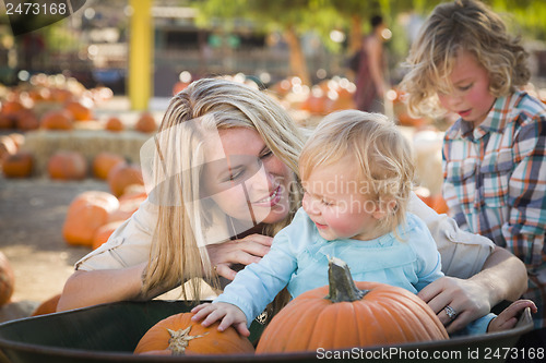 Image of Young Family Enjoys a Day at the Pumpkin Patch