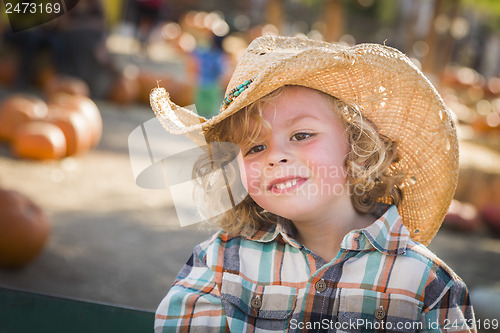 Image of Little Boy in Cowboy Hat at Pumpkin Patch