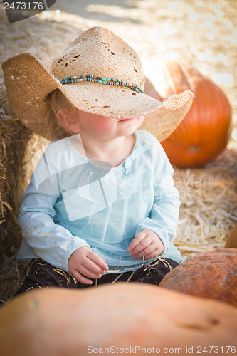 Image of Adorable Baby Girl with Cowboy Hat at the Pumpkin Patch
