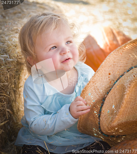 Image of Adorable Baby Girl with Cowboy Hat at the Pumpkin Patch
