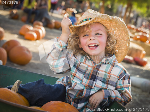 Image of Little Boy in Cowboy Hat at Pumpkin Patch