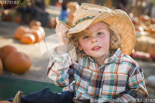 Image of Little Boy in Cowboy Hat at Pumpkin Patch