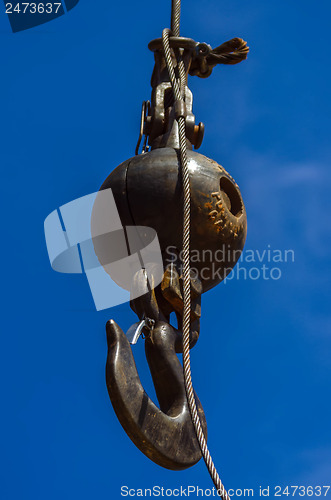 Image of Crane hook on a blue sky