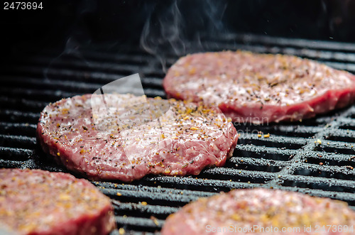 Image of   tasty beef burgers on the grill