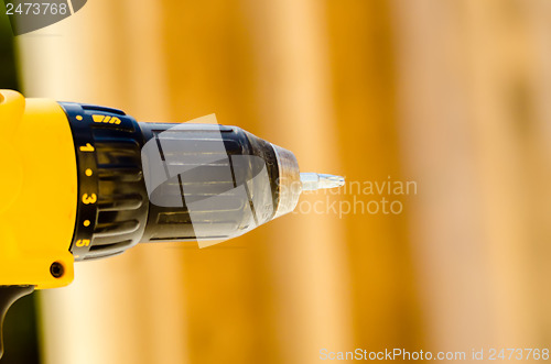 Image of Powerful tip of a drill close up on a construction background