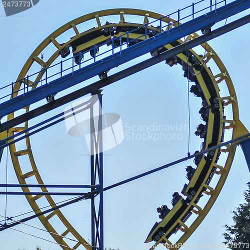 Image of rollercoasters at an amusement park with blue sky