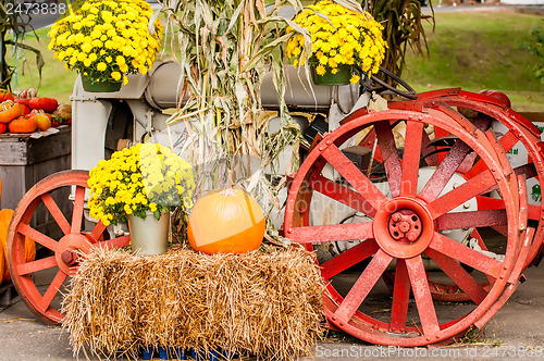 Image of pumpkins next to an old farm tractor