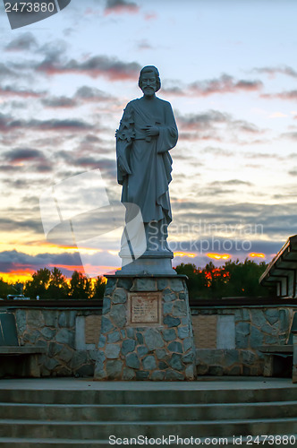 Image of religious statue silhouette at sunset