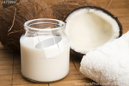 Image of coconut fruit with a jar filled with coco milk