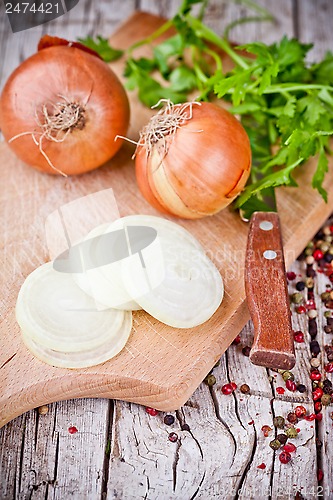 Image of fresh onions, knife, and parsley 