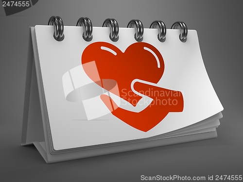 Image of Desktop Calendar with Icon of Heart in the Hand.