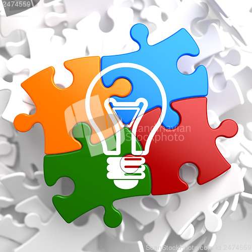 Image of Light Bulb Icon on Multicolor Puzzle.