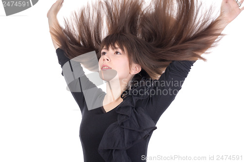 Image of Young woman with her hair flying in the air