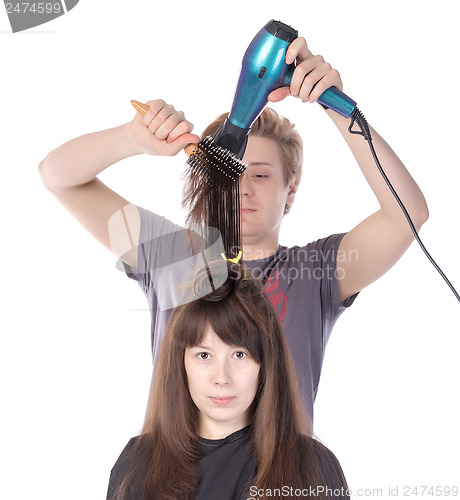 Image of Woman enjoying having her hair blow dried
