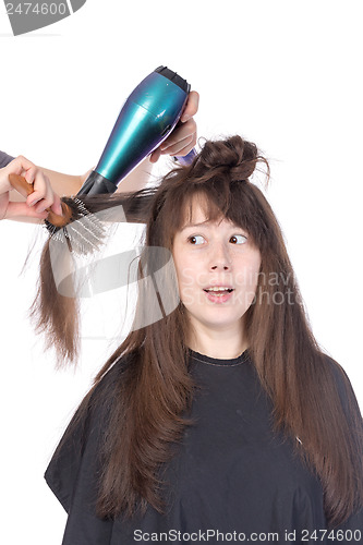 Image of Woman enjoying having her hair blow dried