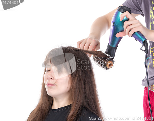 Image of Woman enjoying having her hair blow dried